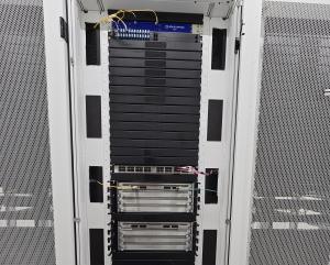 Front view of Huawei CloudEngine 9800 switches mounted in a data center rack by MIRhosting's hardware engineers, fully connected and operational.