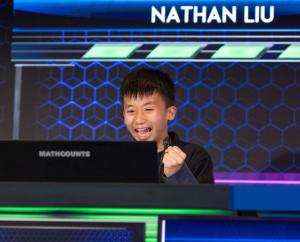 Middle school boy excited and holding his fist up.