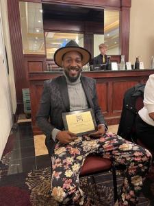 Alvin proudly showing off his award plaque.