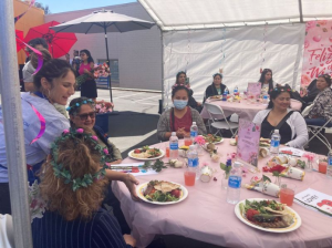 LATLC Volunteer, Alyssa, serving food to the mothers during their sixth annual Mother's Day Event in LA at the Bresee Youth Center