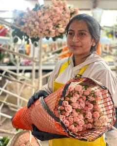 Noam Temkin shows off a beautiful pink bouquet of Ecuadorian flowers at the Del Alma gardens in South America.