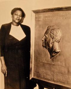 Sculptor Selma Burke standing with her relief of FDR. The artist called New Hope, PA her home for the last 40 years of her life.