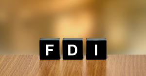 FDI written on black blocks on a wooden surface
