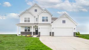 two story home with white farmhouse exterior