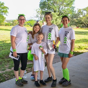 A Happy family dressed in Lyme green showing support for a fun Run