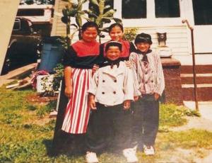 Irma Hersel with childhood friends in Dutch costumes, standing in front of a prickly pear cactus in Holland, Michigan