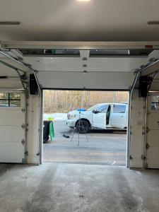 Garage door organizing tools and equipment before an installation job.