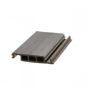 Close-up of a single DuxxBak Dekk composite board showing the patented interlocking profile and textured woodgrain finish