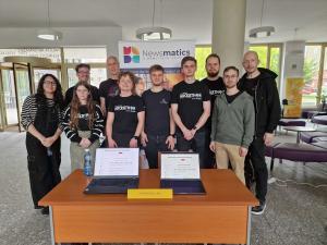 Photo of Newsmatics team standing at desk with laptops open