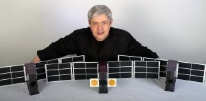 Joe Latrell, Quub's founder, showing the company's  Aurora satellite design