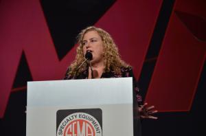 Luanne Brown speaks at a podium during a SEMA industry event.