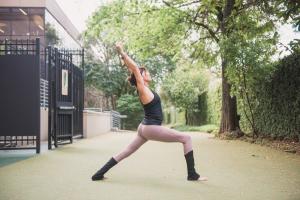 May is Mental Health Awareness Month, and the certified staff of instructors and personal trainers at The Houstonian Hotel, Club & Spa offer their best tips on how to protect mental health through rest, relaxation, and movement woman doing yoga pose