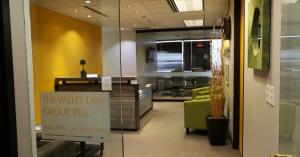 Front-facing view of The Valley Law Group’s reception desk at Suite 1470, photographed from just outside the office door.