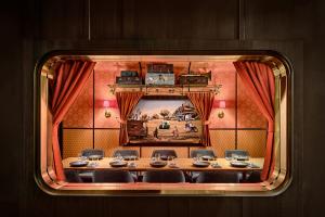 Image of a dining room at Firangi Superstar restaurant that looks like the inside of a train car.