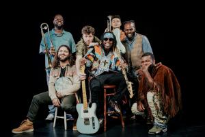 2025 Jersey City Jazz Festival Press Release A photo of The Rumble, posing colorful and ethnic in New Orleans style