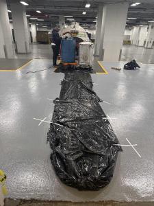 A Picture of Green Oil Recycling Workers Prepping The Area Around The Grease Traps