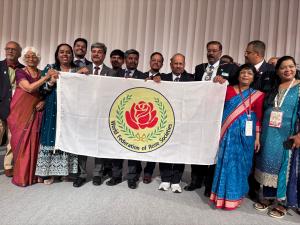The delegation from Madhya Pradesh proudly holds the flag of the World Federation of Rose Societies