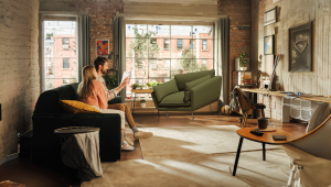 A couple viewing an armchair in AR in their living room using the Fixtuur AR tool on their tablet.