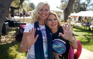Photo of two women waving for the camera