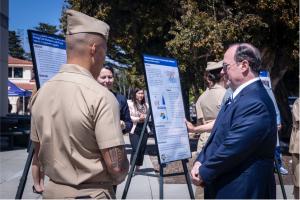 Secretary of the Navy John C. Phelan speaks with Naval Postgraduate School students about their studies and research projects during a visit, May 29. (U.S. Marine Corps photo by Cpl. Chloe N. McAfee)