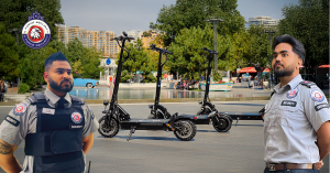 Two G Force Security officers stand guard near electric scooters in a public plaza with parkgoers in the background.