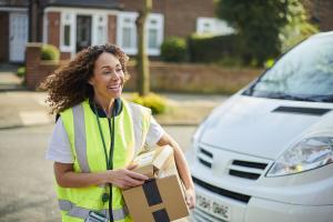 Licensed delivery driver walking with a package, illustrating secure, direct-to-door service in Arizona.