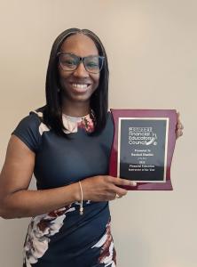 Rachael Hanible holding the Financial Education Instructor of the Year award