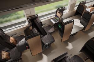 Overhead image showing Butterfly’s 3-seater rail layout mid-conversion, with one seat in recline mode, one side couch setup with a laptop, and one fully flat bed.