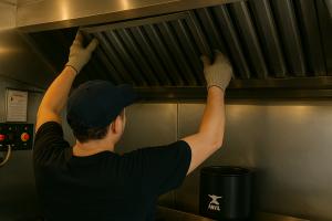 A Done Right worker installing a commercial kitchen hood at a Miami restaurant
