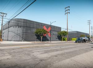 A rare chance to own a piece of Hollywood history has hit the market Street view of the X Buildings studio campus in Burbank, featuring black exterior walls and a red “X” logo.
