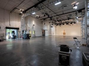 Interior of a fully equipped sound stage at the X Buildings in Burbank, with lighting trusses, high ceilings, and production gear.