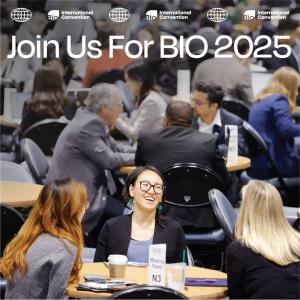 The image shows several different tables with people on chatting. In focus, is a table with three women on in discussion, the one woman we can see with glasses on is laughing. At the top the graphic reads 'Join us for BIO 2025'.