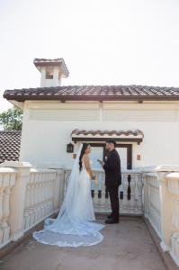 Engaged couple exchanging private vows on the Tuscan balcony at Bonita Ranch, a destination wedding venue in Florida.