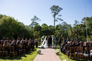 Wedding ceremony by the pond at Bonita Ranch with guests seated, perfect for local and destination weddings in Florida.