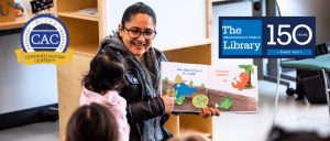 A caregiver reads a colorful children's book to young listeners in Fort Ben Branch of the Indianapolis Public Library.