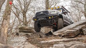 Ride Shocks, a new to market off-road suspension system engineered by the tuning specialists at AccuTune Offroad, is marking one year since its market introduction Toyota Tacoma equipped with Ride Shocks suspension navigating rocky off-road trail during overlanding adventure.