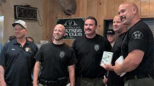 Simi Valley Police Department K9 officers holding plaques after winning the team trapshooting competition.