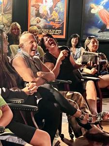 Audience members laughing in the intimate and very funny show: The Magical Mystery Show!