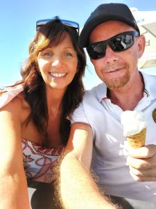 Paul and Robyn Satorius on the beach enjoying ice cream.