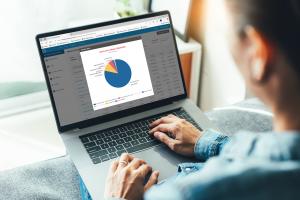 User viewing real-time Co-Op/MDF fund tracking dashboard on Computer Market Research platform, displaying multi-vendor marketing fund summary chart on laptop screen.