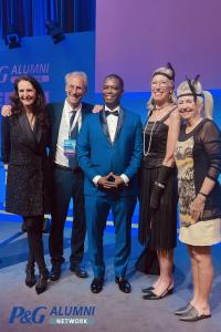 Aliyu Mohammed Ali on stage at the 2025 P&G Alumni Global Conference in Berlin, celebrating the Early Achievement Award alongside fellow honorees and P&G alumni leaders.