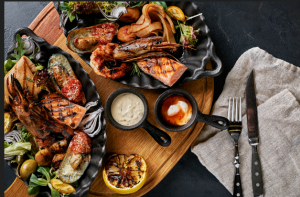 Grilled seafood platter with shrimp, lobster, and mussels, perfect for a gourmet 4th of July celebration.