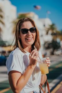 Brooke Davies enjoying a drink en route to tennis, capturing the balance between active living and flexible business success.
