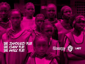 Group of girls in soccer jerseys, the image tinted pink, with the text: she should play, she can plan, she will play