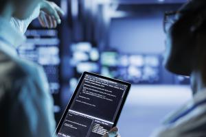 BrickTech, Central Florida’s trusted provider of managed IT solutions, has published a new article titled "Data Breach Prevention: Protecting Your Small Business Two business owners looking at code on a tablet in a data center.