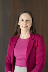 A picture of Bethany Raffanello, Northstar's new Head of School, smiling against a dark background.