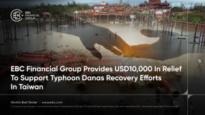 Faded image of a flooded street in Tainan with two hands reaching toward each other—one offering help, the other receiving—symbolising community support and EBC Financial Group’s USD10,000 donation for Typhoon Danas relief - EBC
