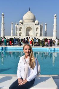 Kerrie Young smiling while traveling in India, representing the freedom of running a portable online business from anywhere in the world.