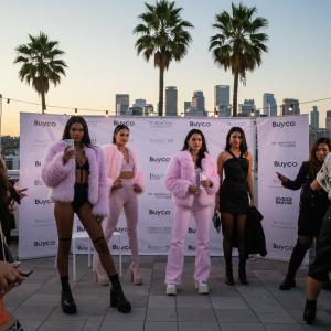 Buyco Announces Winter '25 Fashion Pop-Up Tour Across Major U.S. Cities 13 A stylish woman in a sleek Buyco Winter '25 jacket and leggings, standing confidently in an urban street setting.