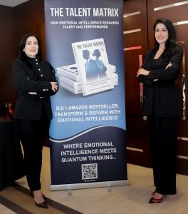 Dr. Soha Chahine and Dr. Ghenwa Habbal standing next to the official banner of The Talent Matrix Playbook during its public debut.